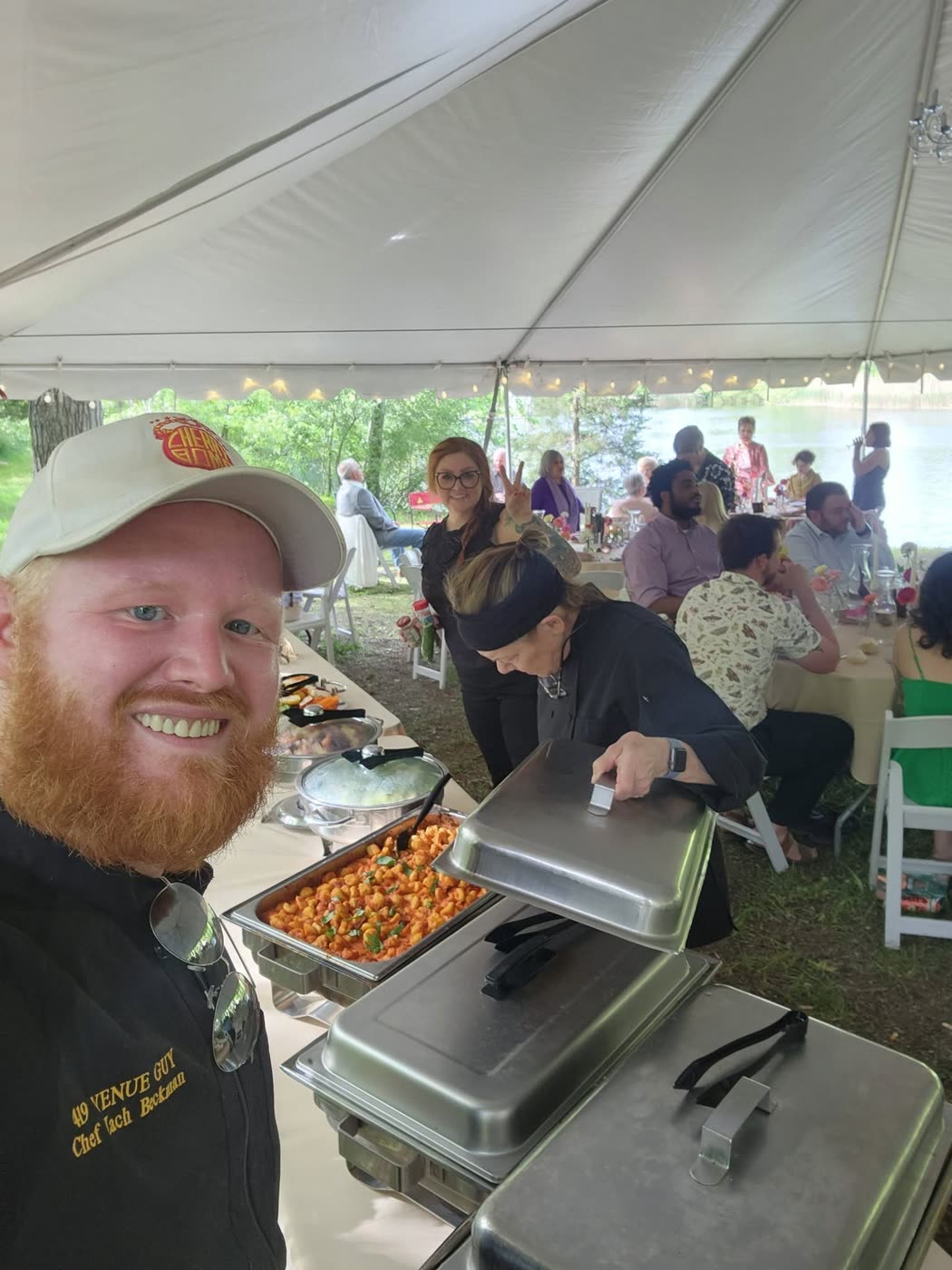 Chef Zach Beckman in his 419 Venue Guy chef jacket at a lakeside wedding, as featured in The News-Messenger