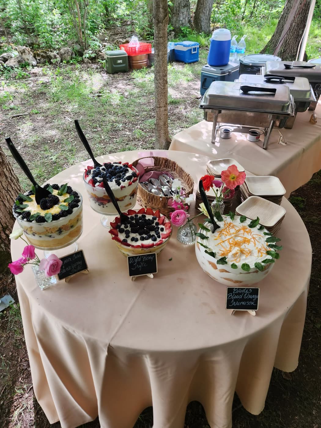 Catered wedding dessert table at an outdoor tented event by 419 Venue Guy