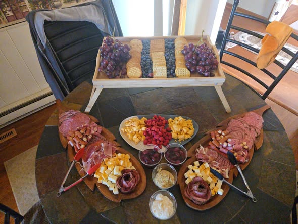 Charcuterie and appetizer spread with fresh fruit and cured meats