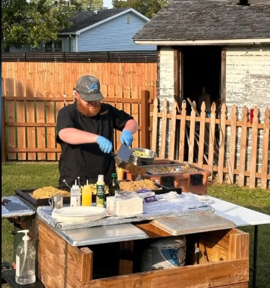 Chef Zach Beckman cooking at an event, as featured in The News-Messenger